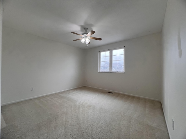 empty room with light carpet and ceiling fan