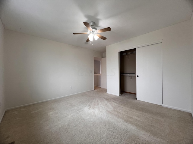 unfurnished bedroom with ceiling fan, light carpet, and a closet