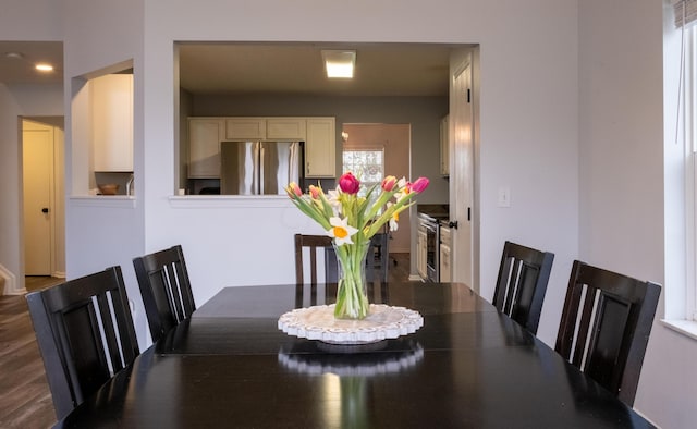 dining area featuring dark wood-type flooring