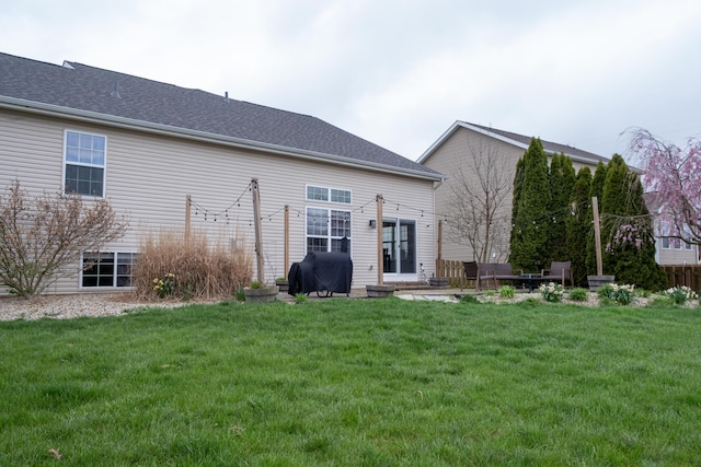 rear view of house featuring a lawn