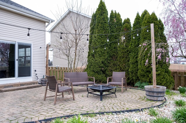 view of patio featuring an outdoor living space with a fire pit