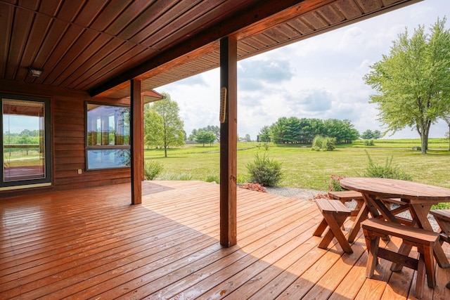 wooden terrace featuring a lawn