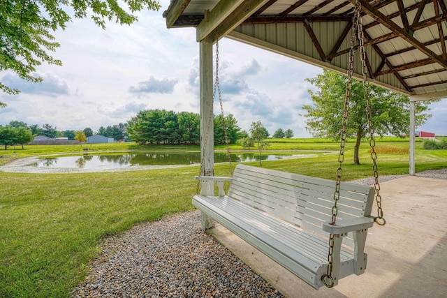 view of community featuring a water view and a lawn