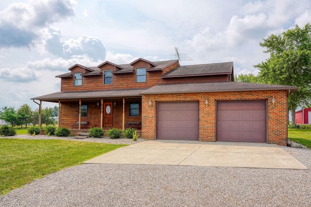 view of front of property with covered porch, a front yard, and a garage