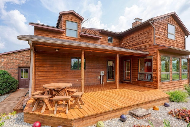 back of house with a wooden deck