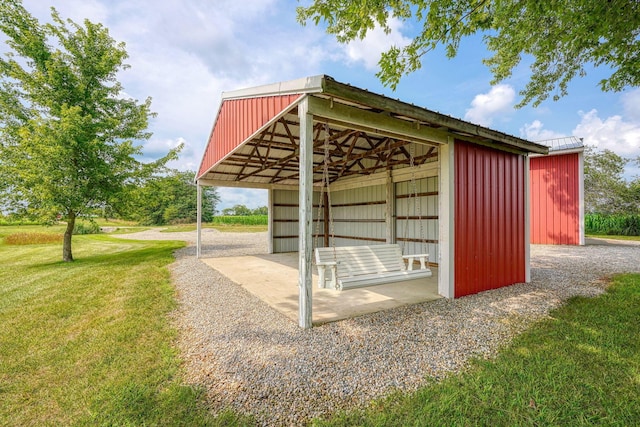 view of community featuring a yard and an outbuilding