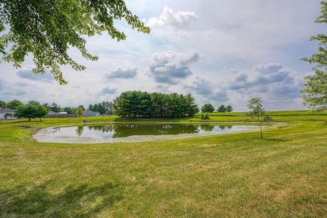 surrounding community featuring a lawn and a water view