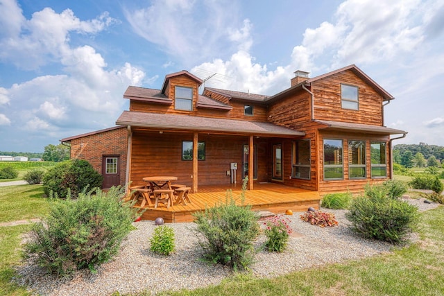 rear view of house with a wooden deck