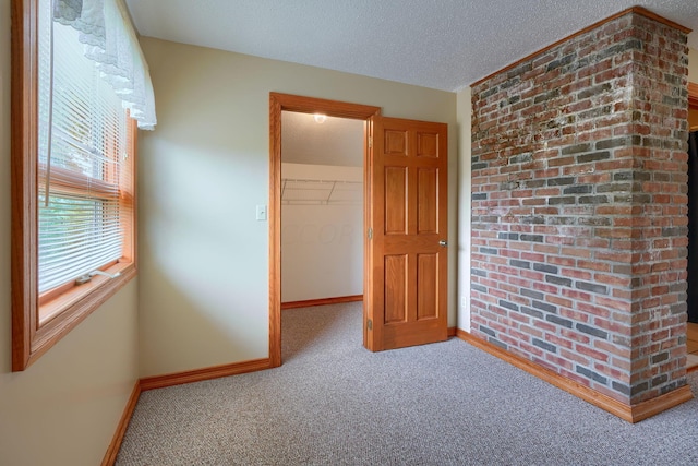 carpeted spare room with a textured ceiling