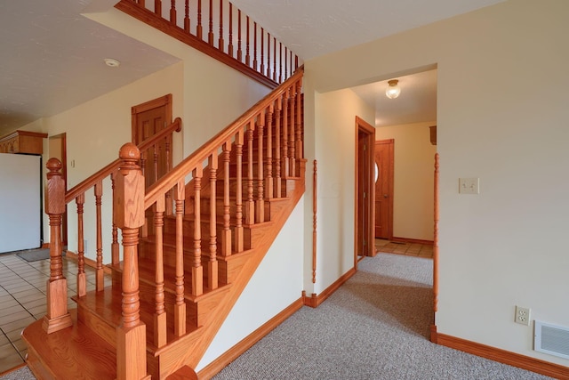 stairway featuring carpet flooring