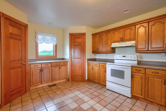 kitchen featuring white range with electric stovetop and light tile patterned flooring