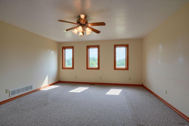 empty room featuring carpet floors and ceiling fan