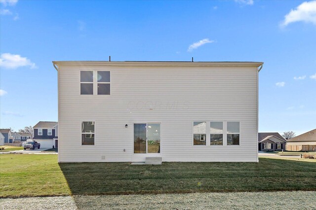 back of house featuring a yard