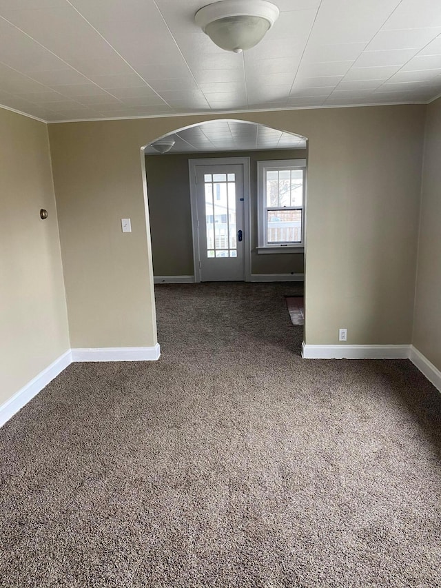 spare room with dark carpet