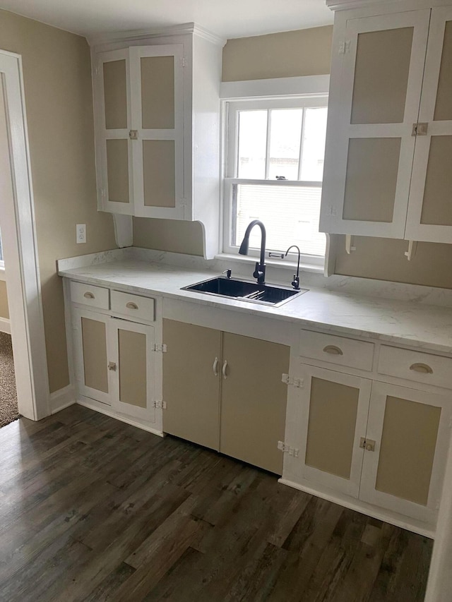 kitchen featuring white cabinetry, sink, and dark hardwood / wood-style floors