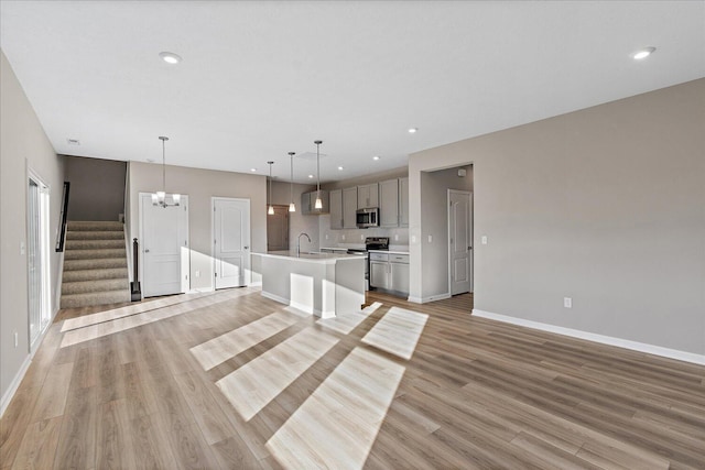 interior space with light hardwood / wood-style floors, sink, and a chandelier