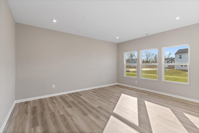 unfurnished room with light wood-type flooring