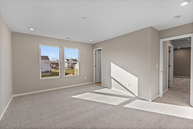 unfurnished room featuring light colored carpet