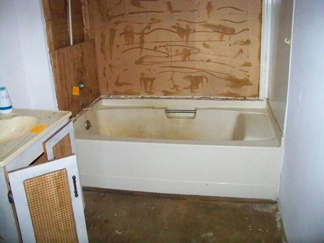 bathroom featuring vanity and a tub