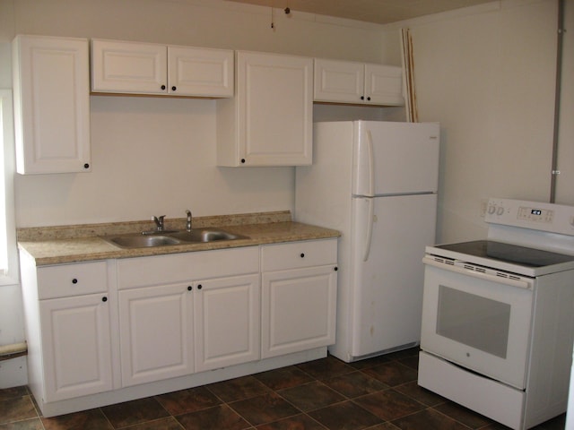 kitchen featuring white cabinets, white appliances, and sink