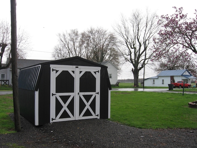 view of outbuilding featuring a yard