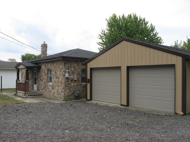 ranch-style house with a garage and an outdoor structure