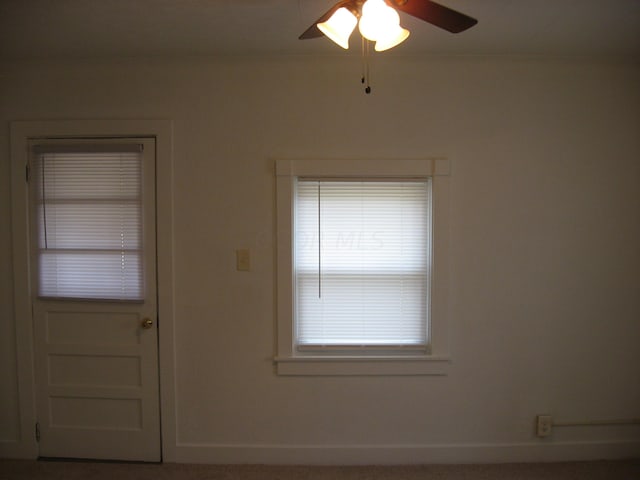 interior space with ceiling fan