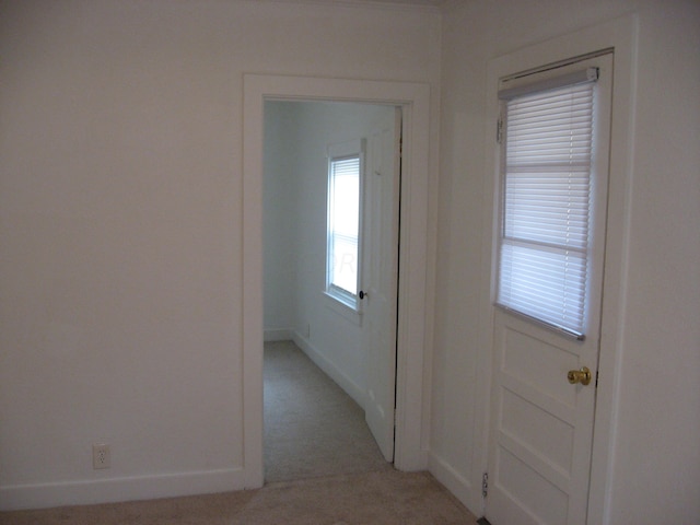 entryway with light colored carpet