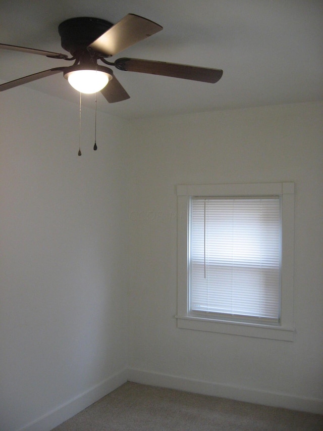 carpeted spare room with ceiling fan