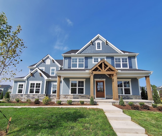 craftsman-style home featuring a porch and a front lawn