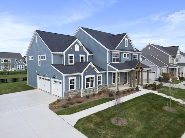 craftsman house featuring a front lawn, a porch, and a garage