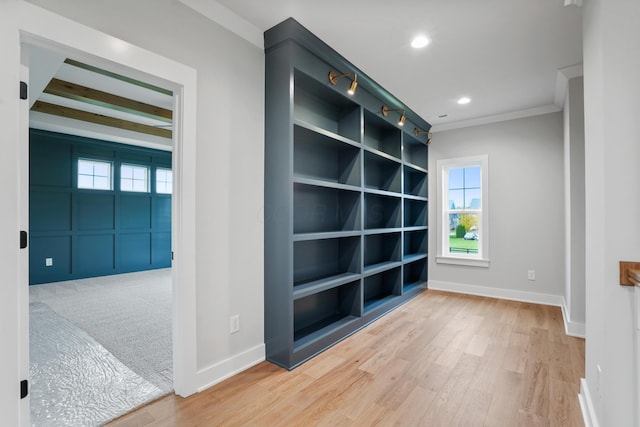 spare room featuring beamed ceiling, crown molding, and hardwood / wood-style flooring