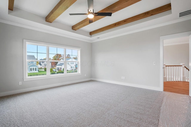 carpeted empty room featuring ceiling fan, beamed ceiling, and ornamental molding