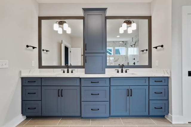 bathroom with tile patterned floors, vanity, a shower, and an inviting chandelier