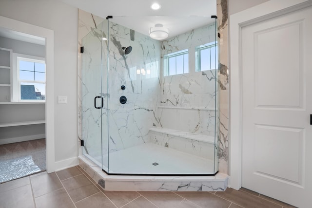 bathroom with tile patterned flooring and walk in shower