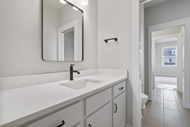 bathroom with tile patterned floors, vanity, and toilet