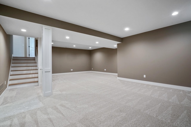 basement featuring light colored carpet