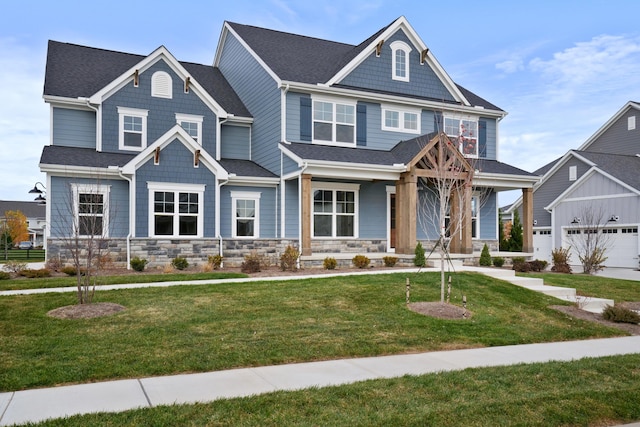 craftsman house with a porch, a garage, and a front lawn