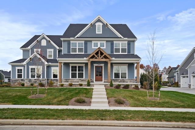 craftsman house with a front yard and covered porch