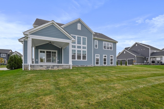 back of house featuring a lawn and ceiling fan