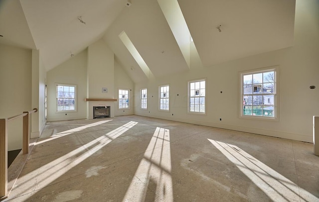 unfurnished living room with a large fireplace and high vaulted ceiling