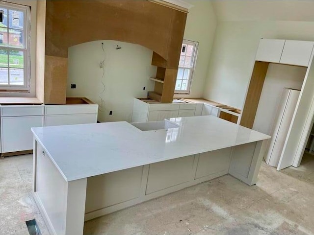 kitchen with white cabinets and a center island