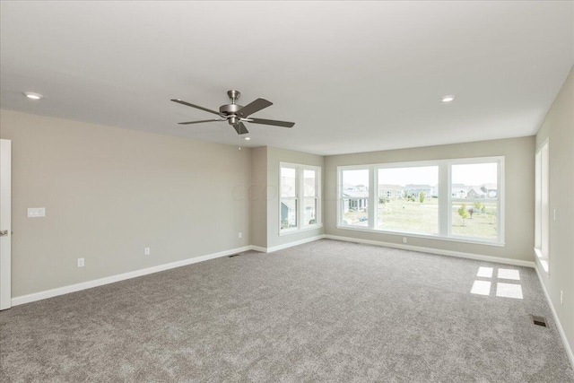 unfurnished room featuring carpet flooring and ceiling fan