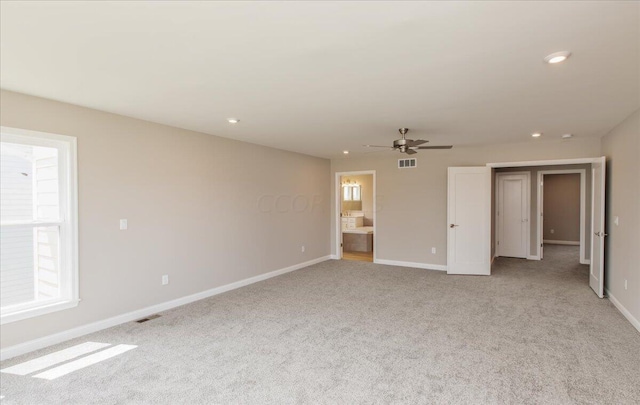 interior space with light carpet and ceiling fan