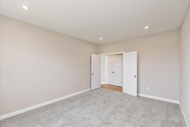 unfurnished bedroom featuring light colored carpet