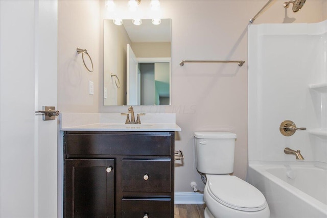 full bathroom with hardwood / wood-style flooring, vanity, toilet, and shower / tub combination