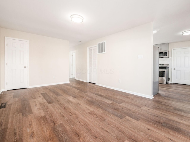 empty room with wood-type flooring