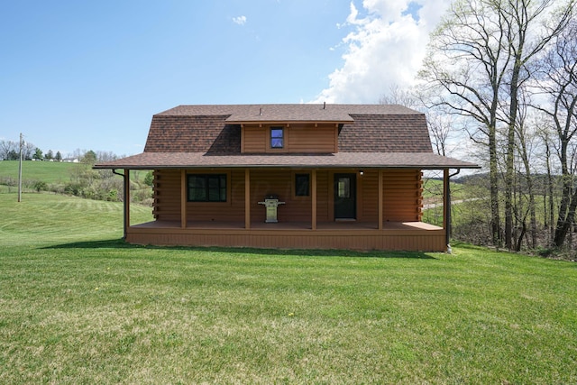 rear view of property featuring a yard