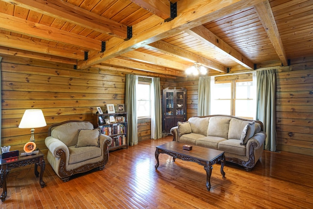 living room featuring beam ceiling, wooden ceiling, plenty of natural light, and hardwood / wood-style floors