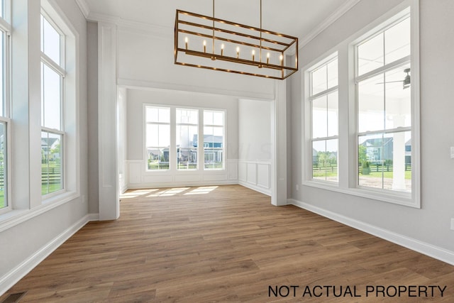 unfurnished sunroom with a healthy amount of sunlight and a chandelier